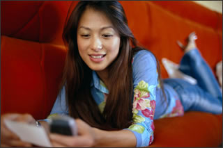 Girl On Mobile Phone. Image © Corbis.